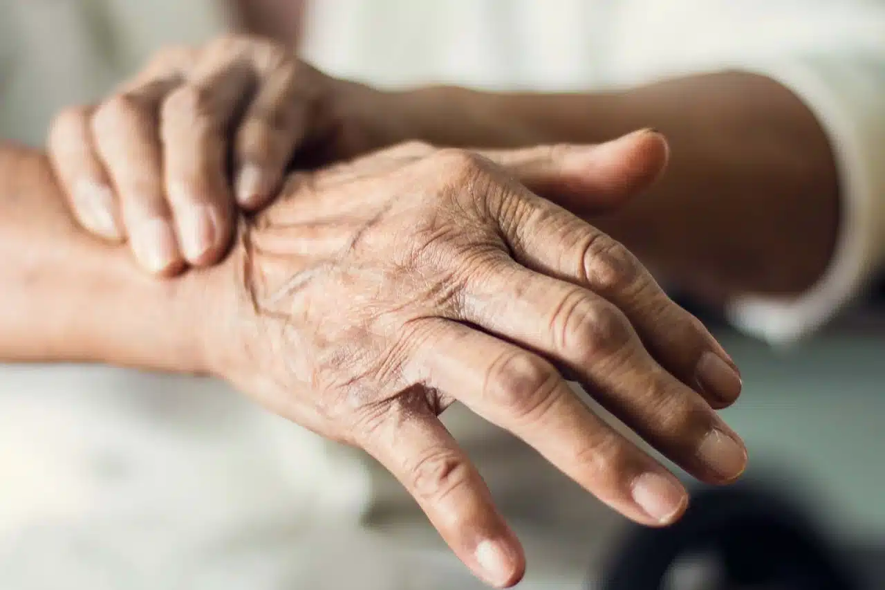 Close-up of the trembling hands of an elderly person with Parkinson's disease