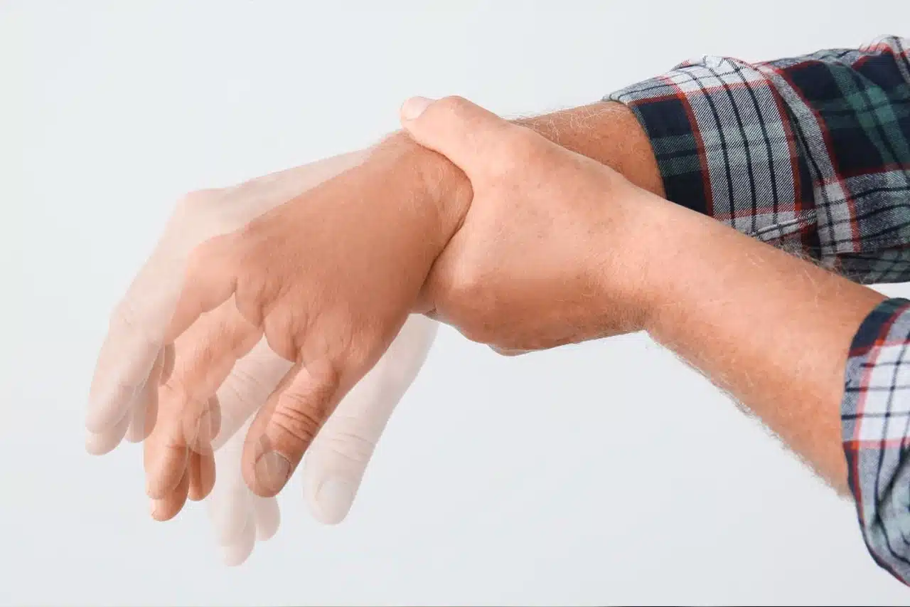 Close-up of the trembling hands of an elderly person with Parkinson's disease