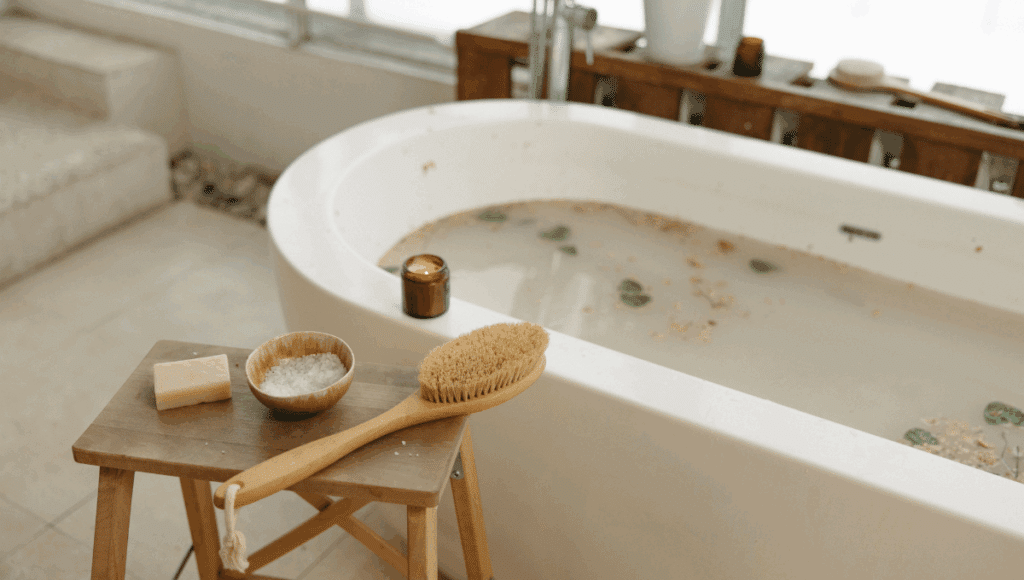 Bathtub prepared for a relaxing bath with natural bath salts, soap, and body brush, promoting safe bathing and comfort for seniors and individuals with limited mobility