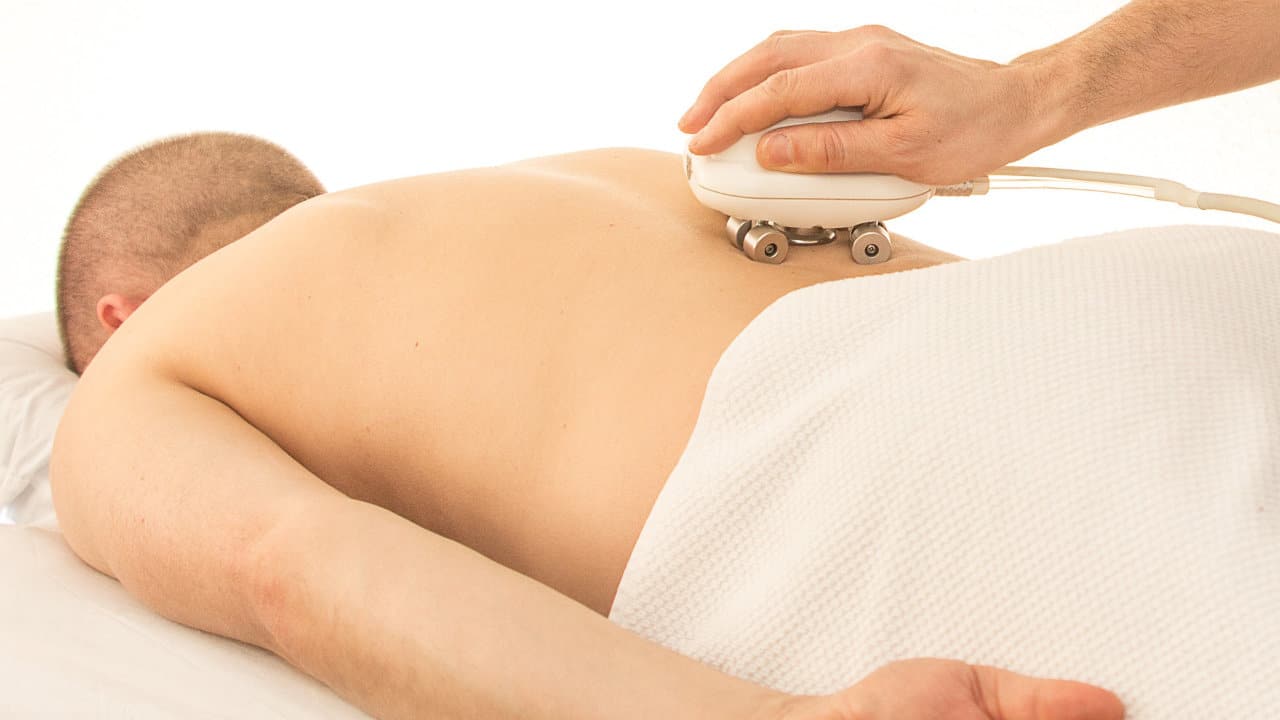 man getting massage therapy for his back