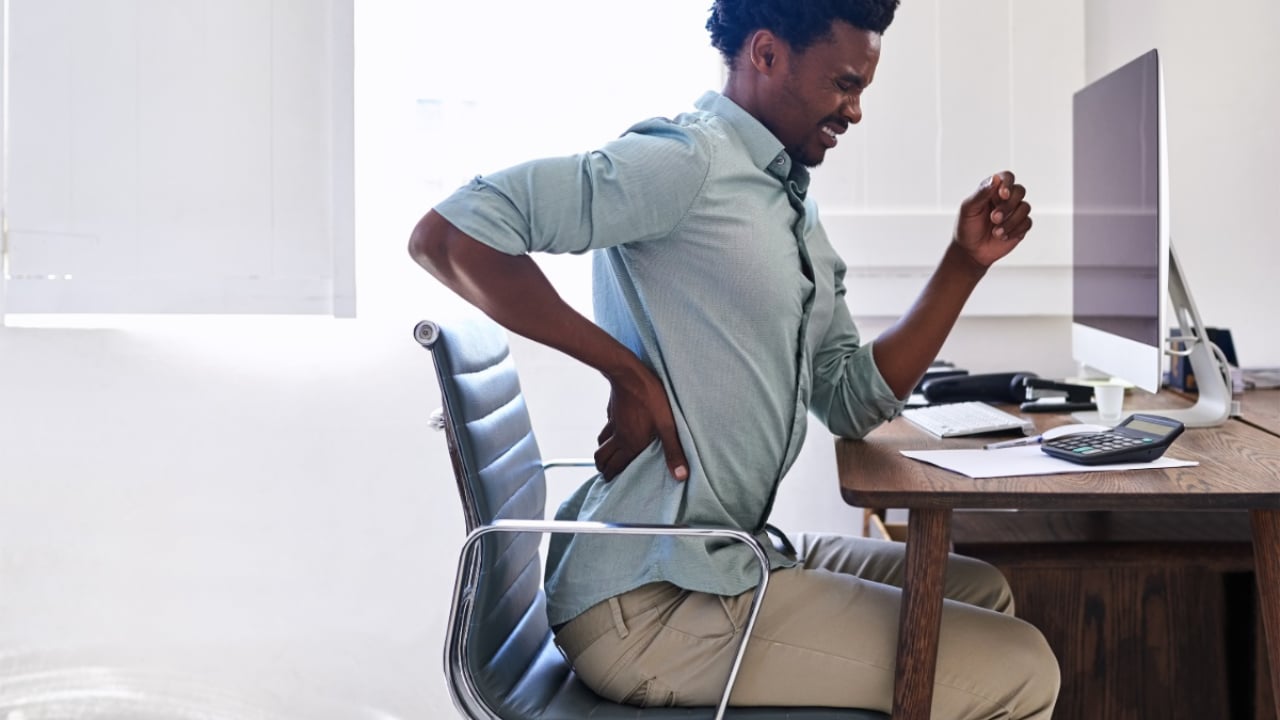 man at his desk with intense back pain
