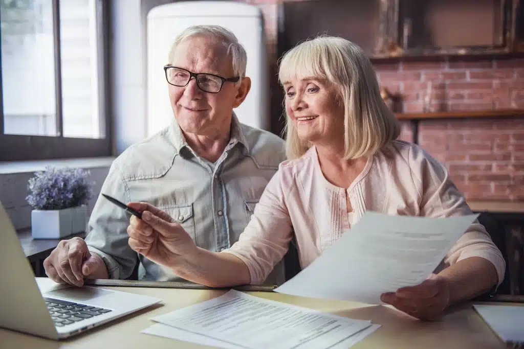 Senior couple reviewing grants and tax credits available for people ages 70 and over in 2026.