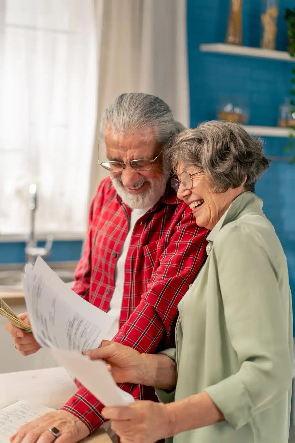 Senior couple reviewing tax credits to prevent falls at home.